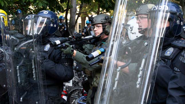 Police officers wearing riot gear shoot rubber bullets at demonstrators outside of the White House, June 1, 2020 in Washington D.C., during a protest over the police killing of George Floyd, an unarmed black man.