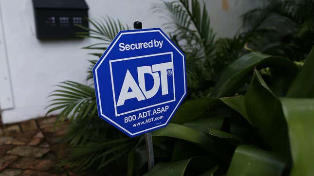An ADT home security alarm sign is seen in front of a home on February 16, 2016 in Miami, Florida.