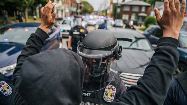 A protester raises his hands in the air during a standoff with law enforcement on September 23, 2020, in Louisville, Kentucky. Protesters marched after a Kentucky Grand Jury indicted one of the three officers involved in the killing of Breonna Taylor with wanton endangerment. Taylor was fatally shot by Louisville Metro Police officers during a no-knock warrant at her apartment on March 13, 2020, in Louisville, Kentucky.