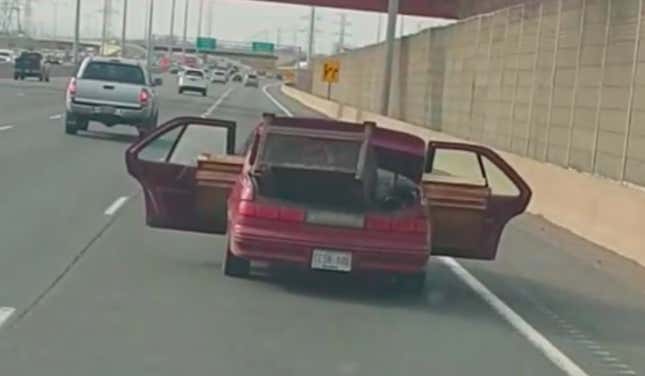 Image for article titled Watch a Chevy Lumina Drive Down a Highway With Lumber Protruding From Its Open Doors