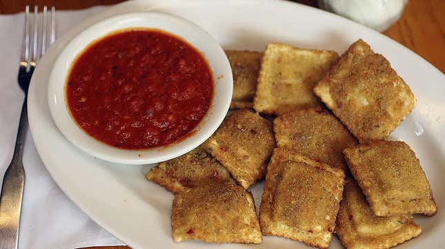 Plate of toasted ravioli with side of red sauce