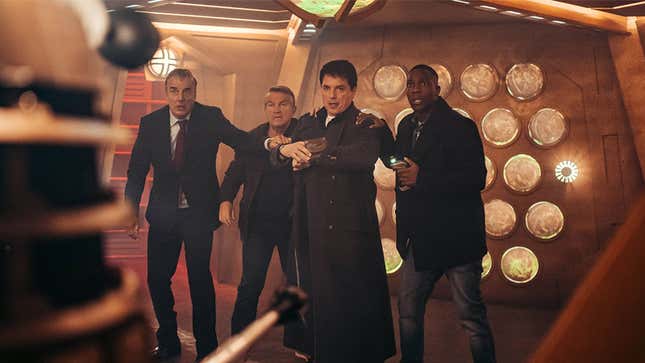 A cyborg Dalek (far left) menaces four characters, including John Barrowman's Captain Jack Harkness, in a scene from "Revolution of the Daleks".