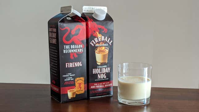 Two cartons of Fireball Non-Alcoholic Cinnamon Holiday Nog beside a glass full of nog