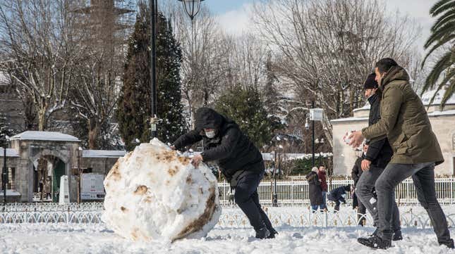 A man pushes a large snowball in front of the Blue Mosque on February 17, 2021 in Istanbul, Turkey. An overnight cold front brought heavy snowfall to Istanbul in the early morning, covering the city in snow, delaying morning commutes, and disrupting ferry services.
