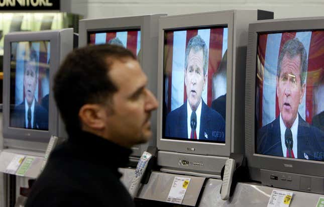 Yancey Wade, of San Francisco, watches U.S. President George W. Bush deliver the State of the Union address on a wall of televisions at a Best Buy store January 20, 2004 in San Francisco.
