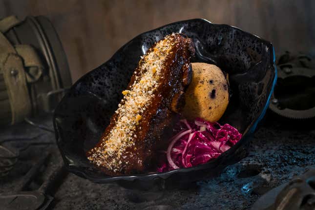 The Smoked Kaadu Ribs, found at Docking Bay 7 Food and Cargo features smoked country sticky pork ribs with blueberry corn muffin and cabbage slaw.