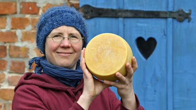 woman proudly holding cheese