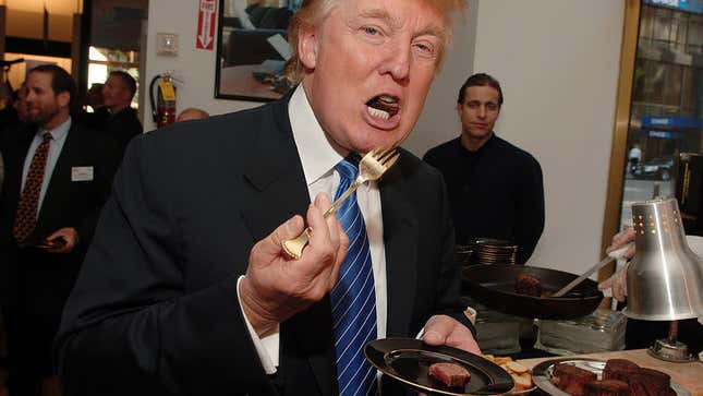 Donald Trump forks a piece of steak into his mouth