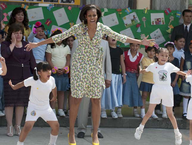 Image for article titled Michelle Obama Powers Through Another Day Of Doing Half-Assed Jumping Jacks In Middle School Gym