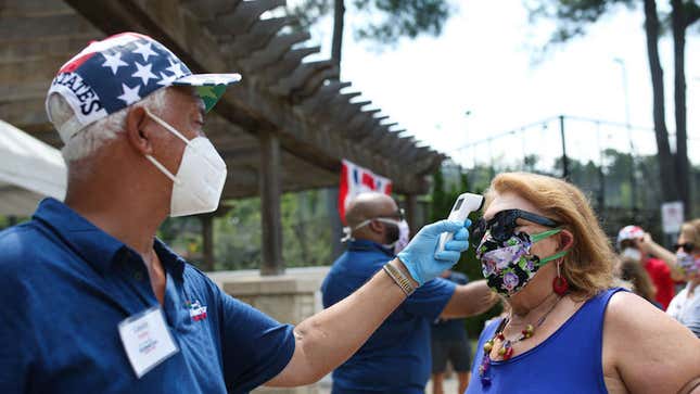 Atlanta, Georgia on July 4, 2020. A woman has her temperature screened before entering the DraftKings All-American Team Cup.