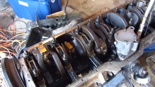 Underneath the oil pan, the crankshaft is easily visible.