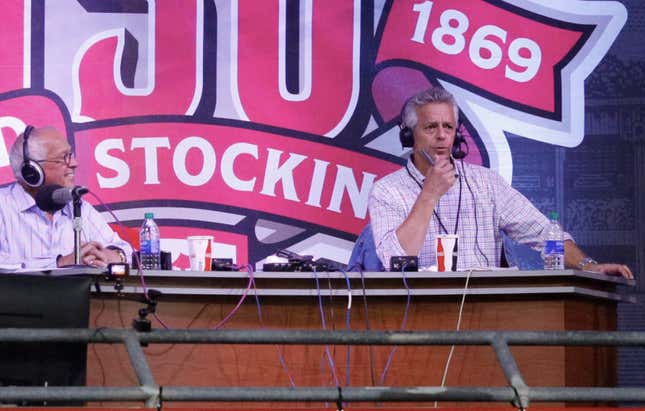 Thom Brennaman calls a game with his father, Marty Brennaman, in 2019.