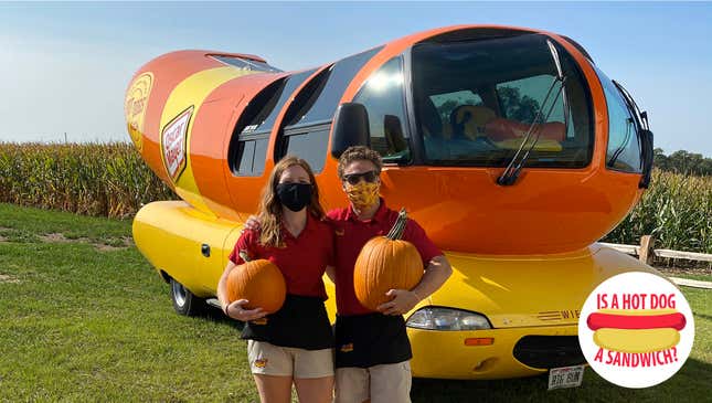Hotdoggers Mustard Mags and Zach n Cheese pose with the Wienermobile