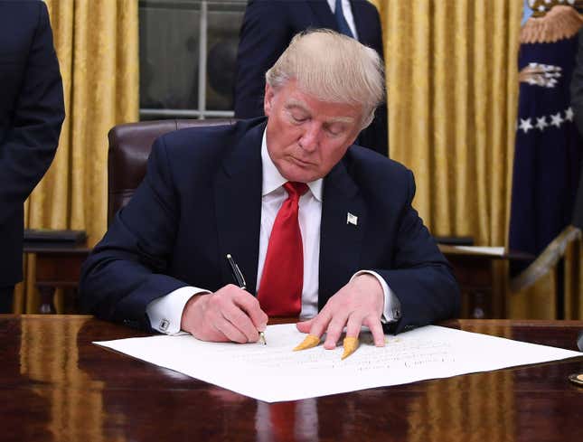 Image for article titled Leftover Bugles Still Stuck To Trump’s Fingers During Bill Signing