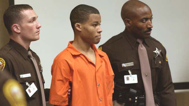 In this Oct. 22, 2003, photo, Lee Boyd Malvo (center) is escorted by deputies as he is brought into court in Virginia Beach, Va.