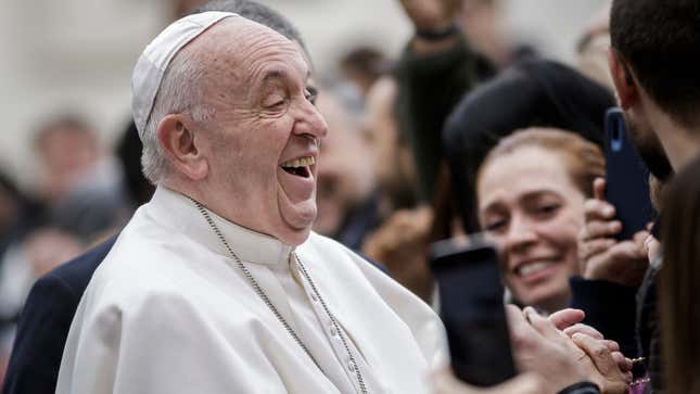 Pope Francis smiles leaving an event