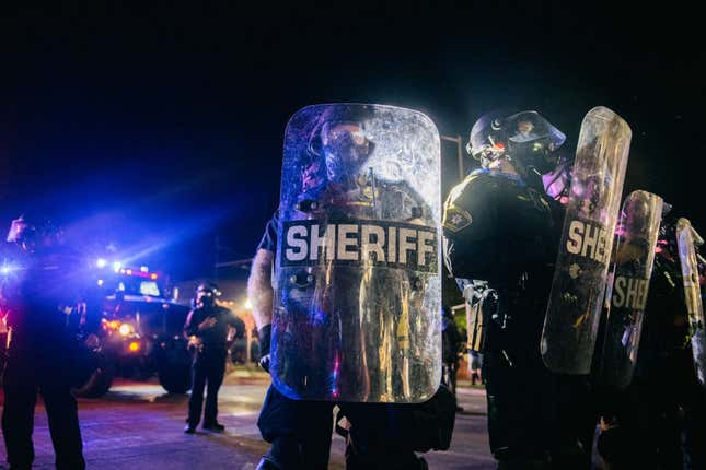 Law enforcement hold a line on August 25, 2020 in Kenosha, Wisconsin. As the city declared a state of emergency curfew, a third night of civil unrest occurred after the shooting of Jacob Blake, 29, on August 23. 