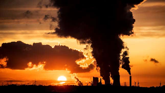 The sunset is pictured as steam rises from the chimneys of Niederaussen lignite-fired power plant in Roggendorf, western Germany on November 8, 2019.