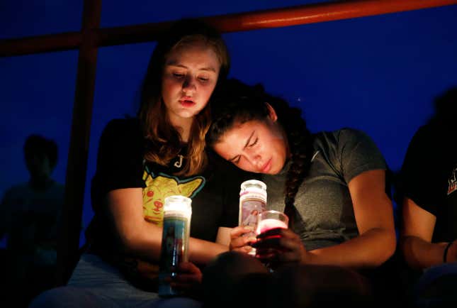 Melody Stout and Hannah Payan comfort each other during a vigil for victims of the shooting that occurred earlier in the day at a shopping center, Aug. 3, 2019, in El Paso, Texas.
