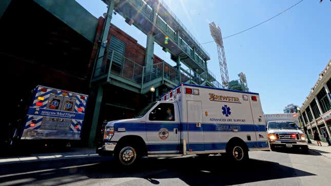 A convoy of 50 ambulances drives down Lansdowne Street on their way to Fenway Park in celebration of National EMS Week on May 20, 2020 in Boston, Massachusetts. 
