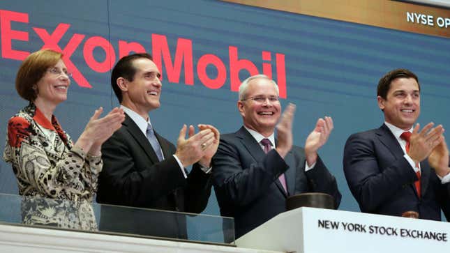Exxon Chairman and CEO Darren Woods, third from left, joins the applause during opening bell ceremonies at the New York Stock Exchange in 2017. Oh, how times have changed.