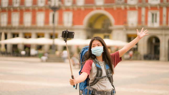 tourist in a mask taking a selfie