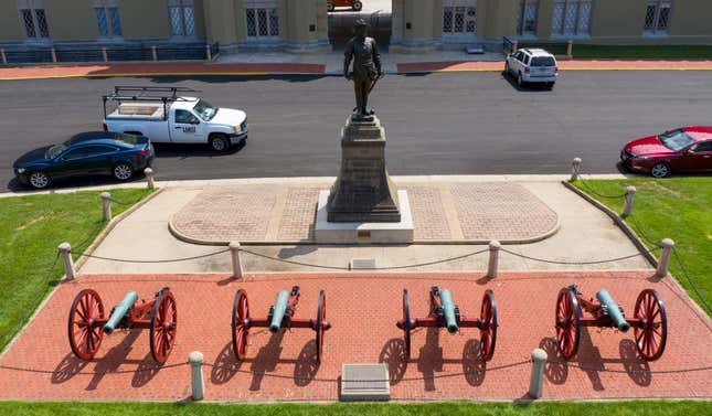 A statue of Confederate General Stonewall Jackson stands behind canons at the entrance to the barracks at Virginia Military Institute Wednesday July 15, 2020, in Lexington, Va.