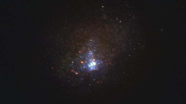 Image of the Kinman Dwarf galaxy, also known as PHL 293B. This tiny galaxy is too far for scientists to pick out individual stars, so what look like stars in this Hubble image are either stars in foreground or gigantic star clusters within the galaxy itself.
