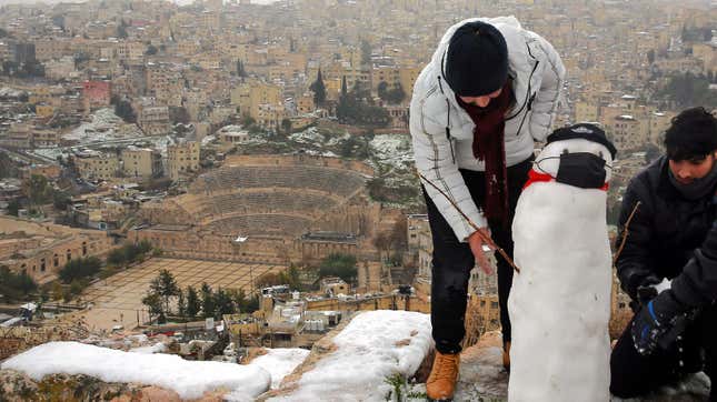 Jordanians make a snowman in the ruins of the Amman Citadel following a snowstorm in the Jordanian capital Amman, on Feb. 18, 2021.