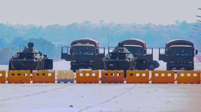 Military vehicles take position on a blockaded road near Myanmar’s Parliament in Naypyidaw on February 4, 2021. 