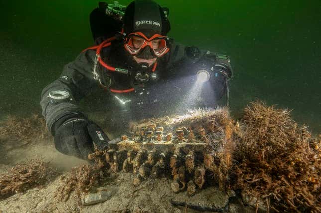 A diver inspecting the historic artifact.