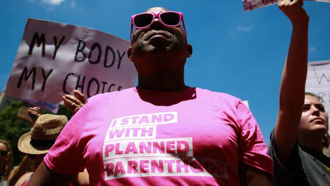 A protester wears an “I stand with Planned Parenthood” shirt at a May 21, 2019, rally in Atlanta against recently passed abortion ban bills. 