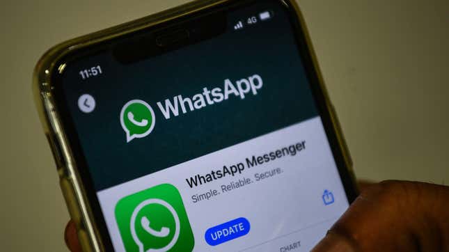 In this photo illustration taken on November 6, 2020, a user updates Facebook’s WhatsApp application on his mobile phone in Mumbai. 