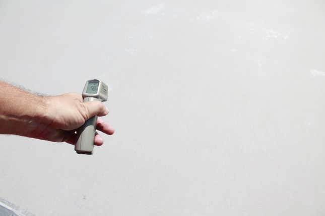 Taking the temperature of a recently-whitened pavement in LA. Image: Nate Berg