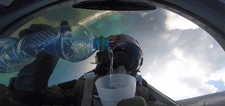 Cool View Of A Pilot Pouring Water Upside Down While Doing A