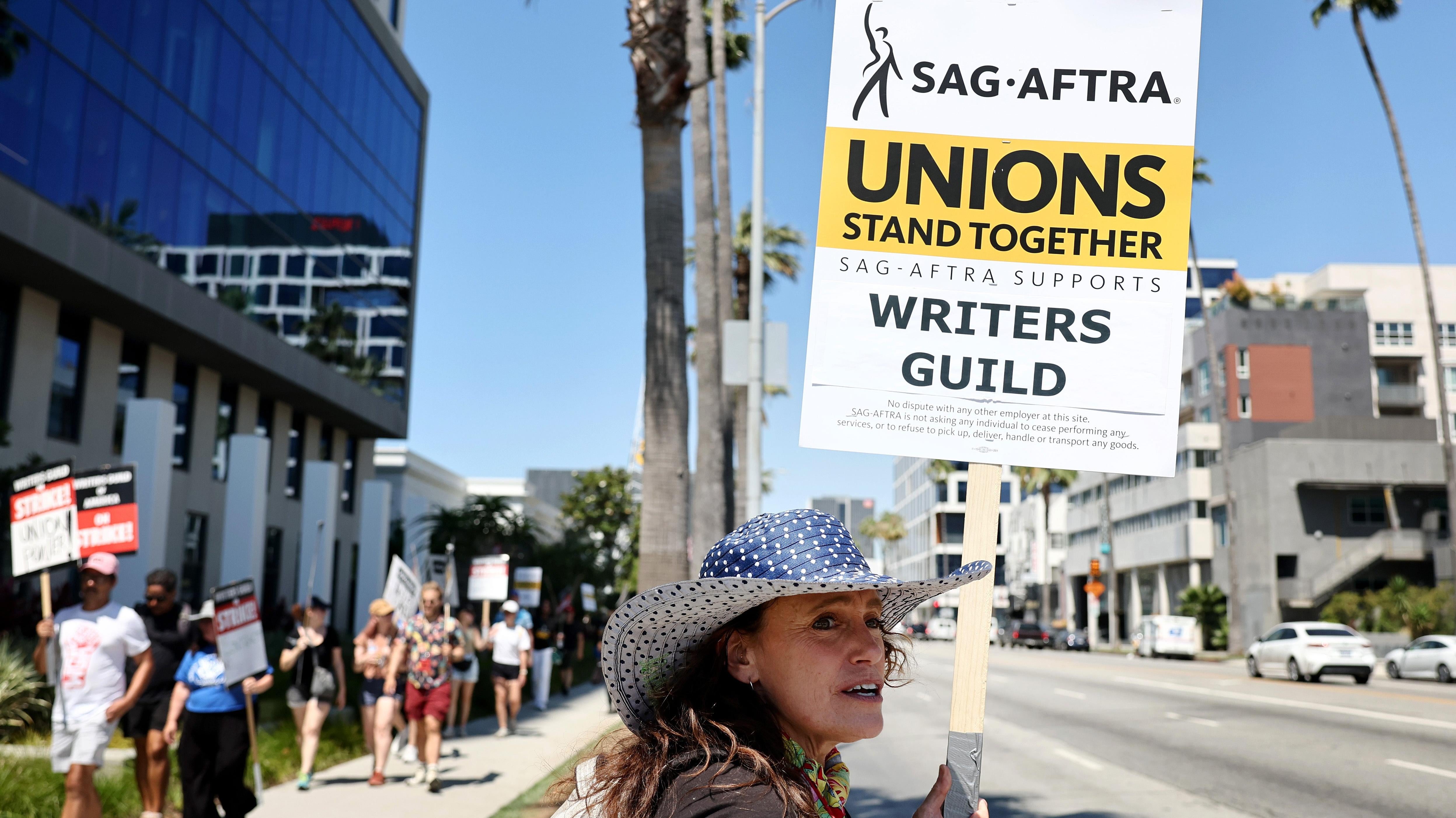 عضوة AG-AFTRA كريستين روبرت تضامن مع عمال WGA (نقابة الكتاب الأمريكية) المضربين خارج مكاتب Netflix في 12 يوليو 2023.
