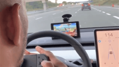 ufc fighter plays smash while his tesla drives itself