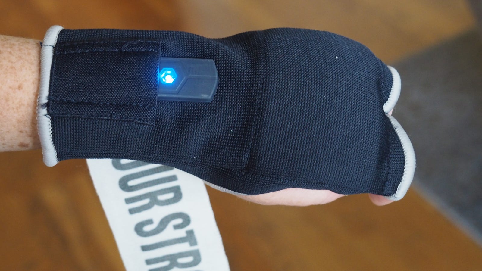 The tracker with the blue light slides into the blue hand wrap.