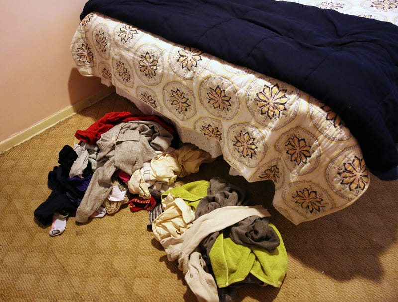 Pile Of Dirty Clothes On Bedroom Floor Starting To Mix With Pile