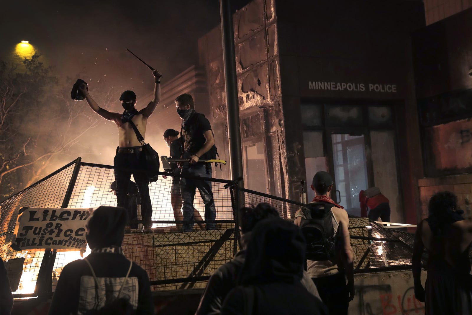 Protesters gather in front of the 3rd precinct police building while it burns on May 28, 2020 in Minneapolis, Minnesota.
