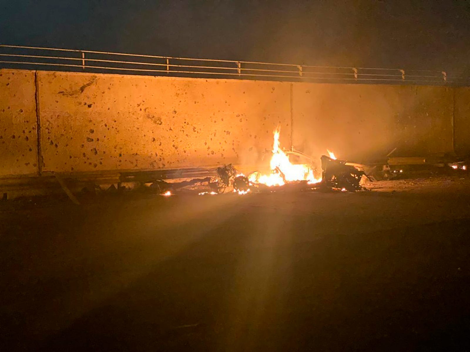 This image released by the Iraqi Prime Minister's News shows a car burning at Baghdad International Airport following an airplane, in Baghdad, Iraq, early Friday, Jan. 3, 2020.