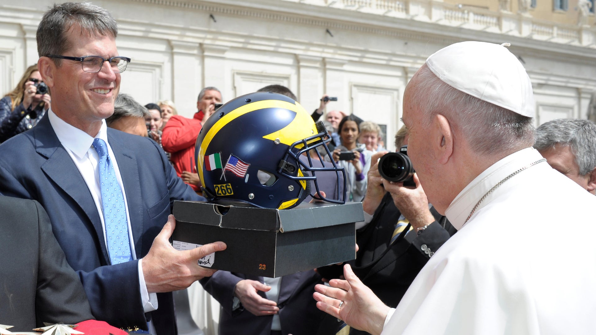 Harbs blesses the pope with a football helmet. Czakh5aymk9qpzx2rgwh