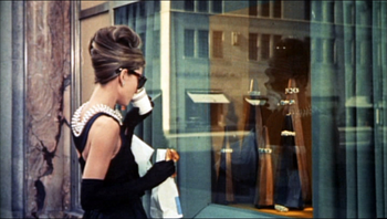 Audrey Hepburn in the iconic Givenchy dress, having breakfast at Tiffany&#039;s.