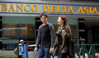 People walk past a branch of Banco Delta Asia in Macau ,China , Wednesday 14 March 2007. Chairman Stanley Au of Banco Delta Asia SARL , on Friday 16 March 2007, denied wrongdoing over frozen North Korean assets and said the bank has complied with Macau law. China on Thursday criticized a US decision to ban all transactions with the Macau bank linked to illicit North Korean funds.