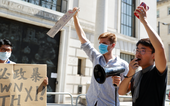 Simon Cheng speaks in a megaphone during a protest