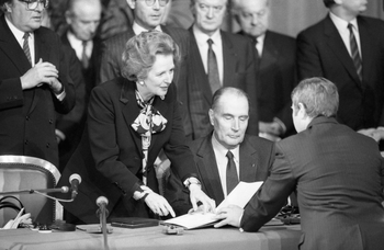 Britain&#039;s Prime Minister Margaret Thatcher and French President Francois Mitterrand with the guest book at Lille Town Hall in northern France on Jan. 20, 1986, after announcing the Anglo-French agreement to build a Channel Tunnel rail link under the English Channel. The tunnel will be a high speed rain link.