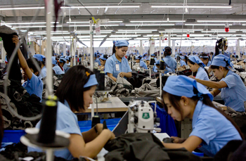 In this Sept. 29, 2015 photo, workers in the Great Forever factory stitch clothes in the Hlaing Tharyar industrial zone outside Yangon, Myanmar. After decades of isolation and underdevelopment, the lack of even basic industries means apparel makers must import everything they use to make garments: thread, cloth, zippers, buttons. (AP Photo/Gemunu Amarasinghe)