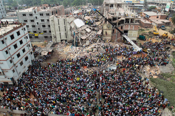 FILE - In this April 25, 2013, file photo, Bangladeshi people gather as rescuers look for survivors and victims at the site of a building that collapsed a day earlier, in Savar, near Dhaka, Bangladesh. A Bangladesh court on Monday, July 18, 2016, indicted 41 people for murder in the 2013 deaths of more than 1,100 people in the collapse of a building that housed five garment factories outside the capital. (AP Photo/A.M.Ahad, File)