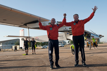 Pilots Bertrand Piccard, left and Andre Borschberg, right, celebrate the landing of the solar-powered plane at San Pablo airport in Seville, Spain on Thursday, June 23, 2016. An experimental solar-powered airplane Thursday completed an unprecedented three-day flight across the Atlantic in the latest leg of its globe-circling voyage. (AP Photo/Laura Leon)