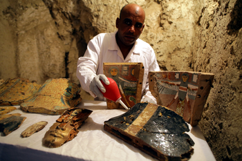 epa06378510 An Egyptian archaeologist works on restoring items at a recently found tomb and re-discovery of an older one, at Draa Abul Naga necropolis on Luxor?s west bank, 700km south of Cairo, Egypt, 09 December 2017. Egypt&#039;s Ministry of Antiquities announced the discovery of a tomb from the New Kingdom that belongs to the old Egyptian deity Amun&#039;s Goldsmith, Amenemhat (tomb number Kampp 390) and a burial shaft housing the mummy of a lady and her two children. The newly discovered tomb includes an entrance located in the courtyard of another Middle Kingdom tomb number Kampp150. EPA-EFE/KHALED ELFIQI